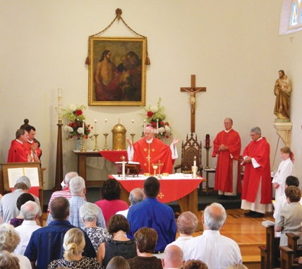 The congregation at St. Thomas Church knelt during the Liturgy of the Eucharist at the bicentennial Mass. The congregation at St. Thomas Church knelt during the Liturgy of the Eucharist at the bicentennial Mass.