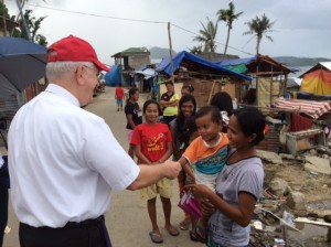 Archbishop greets a mother and child in the Philippines. 