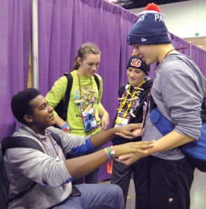 During a break at the National Catholic Youth Conference in Indianapolis Nov. 21, Shaquan Hays, seated, and Nicholas Terrell played a game while Kirsten Crepps, center, and Will Taylor looked on. The four teens were part of the delegation from the Archdiocese of Louisville. Record Photo by Ruby Thomas